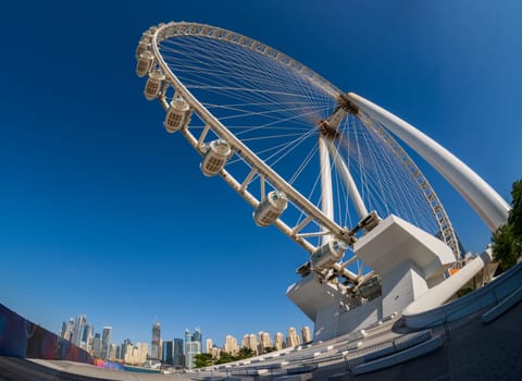 Looking up with fish eye lens at Ain Dubai Observation Wheel on BlueWaters Island with JBR Beach in background