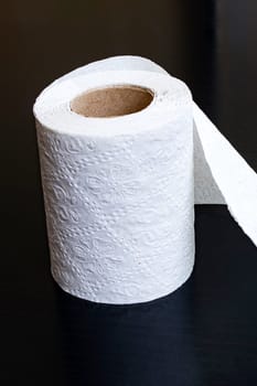 White toilet paper on a wooden table close up