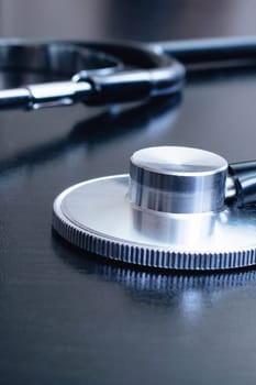 Medical stethoscope on a black table close up