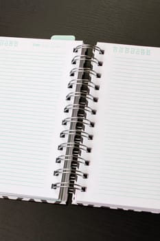 Blank open notepad page close up on wooden table