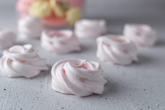 Meringue. Light dessert of whipped egg whites on a gray background.