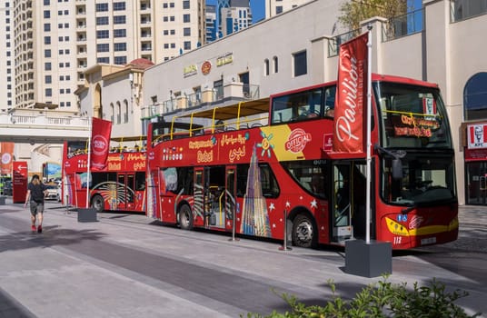 Dubai, UAE - 3 April 2023: Red city sightseeing bus for hop on hop off tour of the city