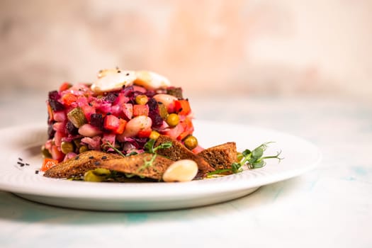 salad vinaigrette with black bread on a plate.