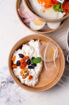 Breakfast cottage cheese with dried fruits top view. tomorrow in craft dishes.