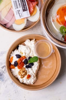 Breakfast cottage cheese with dried fruits top view. tomorrow in craft dishes.