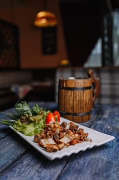 appetizer of small fried ribs on a white plate.