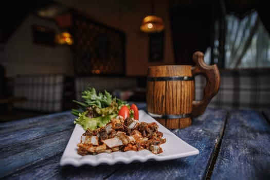 appetizer of small fried ribs on a white plate.