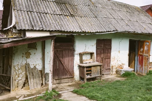 Old abandoned ruined house in dead village. Deserted and destroyed dwelling on farm yard. Neglected building countryside