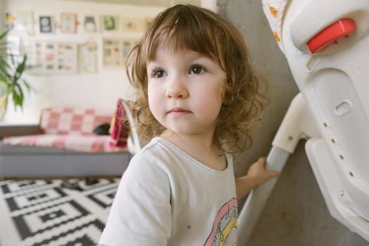 The portrait of blond small girl. Indoor.