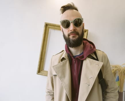 young handsome bearded hipster man in the city.