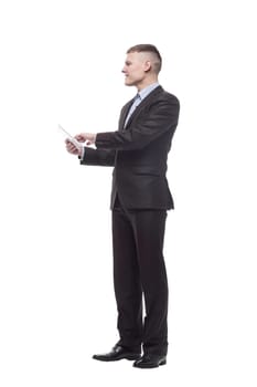 in full growth. happy young businessman with a digital tablet . isolated on a white background.