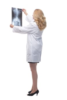 side view. female doctor looking at an x-ray. isolated on a white background.