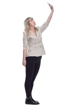 side view. casual woman in a white jacket taking a selfie. isolated on a white background.