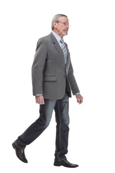 full length picture of a mid aged business man walking towards the camera and smiling. isolated on a white background