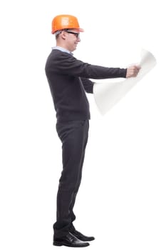 sideview full length portrait of serious businessman in orange hardhat with blueprint looking up. isolated on white background