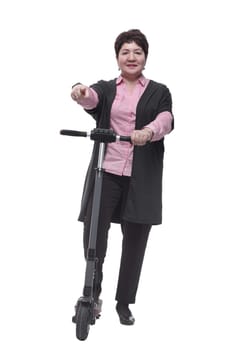 in full growth. confident mature woman with an electric scooter . isolated on a white background
