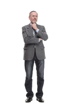 Senior man stands, arms crossed, with one hand on chin in thoughtful full length pose isolated on white