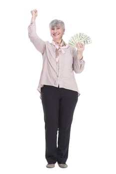 in full growth. happy old lady with a wad of dollar bills . isolated on a white background.