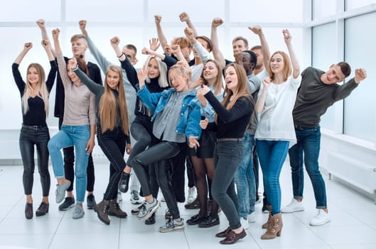 in full growth. a group of happy youths who are pointing ahead