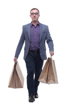 Picture of handsome smiling man in suit with shopping bags looking at camera