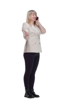 side view. casual woman talking on the phone while standing in front of a white screen . isolated on a white background.