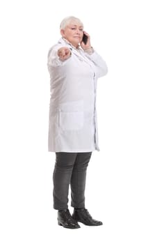 Portrait of middle aged female doctor talking with somebody on her mobile phone. Concept of healthcare worker.