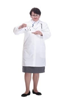 in full growth. senior female medic with sanitizer in hand. isolated on a white background.