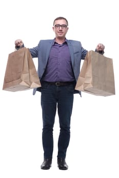 Good looking young man holding shoping bags, standing isolated over white background