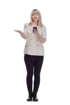 in full growth. attractive woman reading message on her smartphone . isolated on a white background.