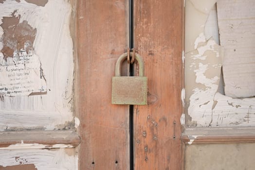 Old rusty lock on an old wooden barn door. High quality photo