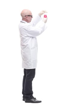 in full growth. competent doctor with a laboratory flask. isolated on a white background.