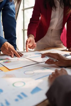 Close up of Diverse colleagues gather brainstorm discuss financial statistics at office meeting. finance, teamwork, Big data Graphs Charts concept.