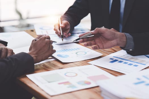 Close up of Diverse colleagues gather brainstorm discuss financial statistics at office meeting. finance, teamwork, Big data Graphs Charts concept.