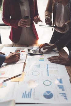 Close up of Diverse colleagues gather brainstorm discuss financial statistics at office meeting. finance, teamwork, Big data Graphs Charts concept.