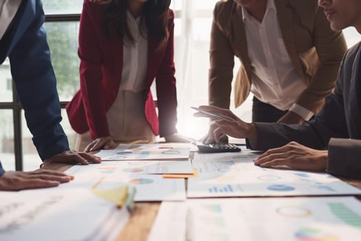 Close up of Diverse colleagues gather brainstorm discuss financial statistics at office meeting. finance, teamwork, Big data Graphs Charts concept.