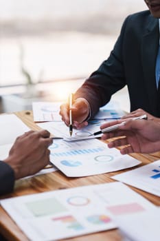 Close up of Diverse colleagues gather brainstorm discuss financial statistics at office meeting. finance, teamwork, Big data Graphs Charts concept.