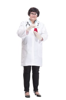 in full growth. senior female doctor showing her visiting card . isolated on a white background.