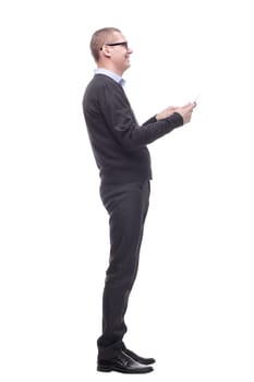Side view of smiling business man using his tablet computer against a white background
