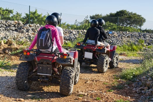 Friends driving off-road with quad bike or ATV. Group Of Friends Riding Together atv. Off Road adventure. activity