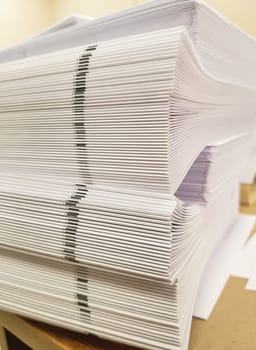 A stack of blank paper, book blocks prepared for binding in a printing house.