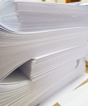 A stack of blank paper, book blocks prepared for binding in a printing house.