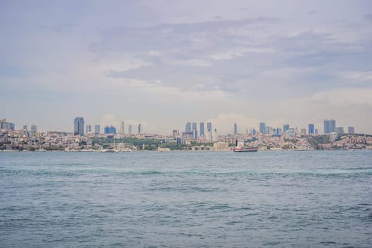 Istanbul at sunset, Turkey. Tourist boat sails on Golden Horn in summer. Beautiful sunny view of Istanbul waterfront with old mosque. Concept of travel, tourism and vacation in Istanbul and Turkey. Turkiye.