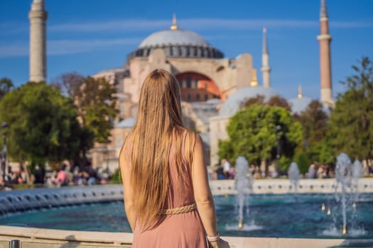 Woman enjoy beautiful view on Hagia Sophia Cathedral, famous islamic Landmark mosque, Travel to Istanbul, Turkey. Sunny day architecture and Hagia Sophia Museum, in Eminonu, istanbul, Turkey. Turkiye.