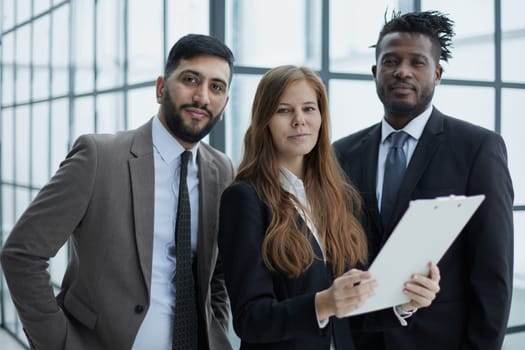 Colleagues Holding Files with Business Report and Reading it Together at Work