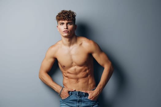 man jeans care muscle health male naked lifestyle fit curly gray background healthy young handsome beauty fashion