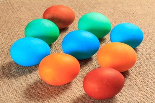 Painted eggs with sackcloth on the background. Traditional orthodox christian easter food. Top view.