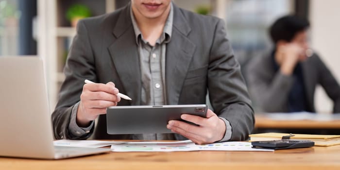 Accountant man working on digital tablet and do document, tax, exchange, research, accounting and Financial advisor concept.