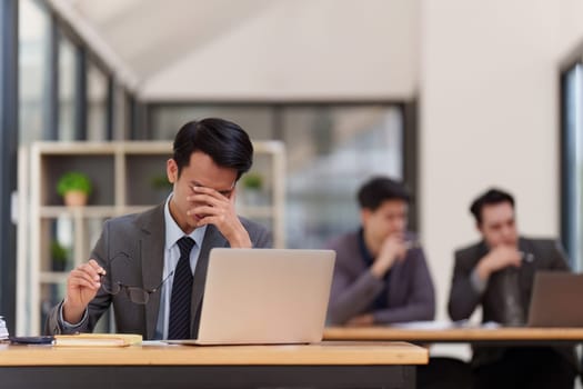 Stressed business person working and research strategy on laptop and looking worried, tired, finance, teamwork, Big data Graphs Charts concept.