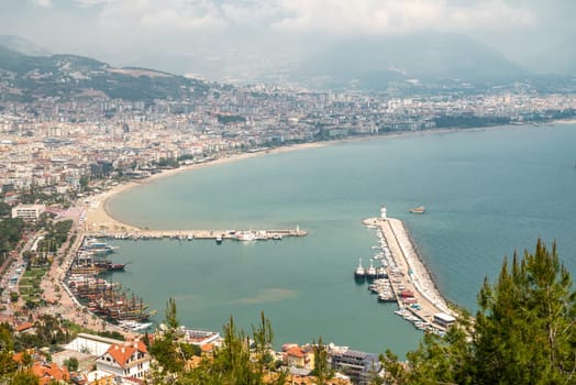 Aerial view of Alanya marina and city on a cloudy day