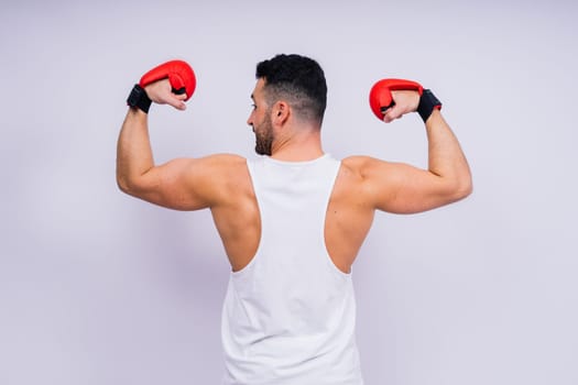 Young caucasian handsome man isolated on a white background with boxing gloves